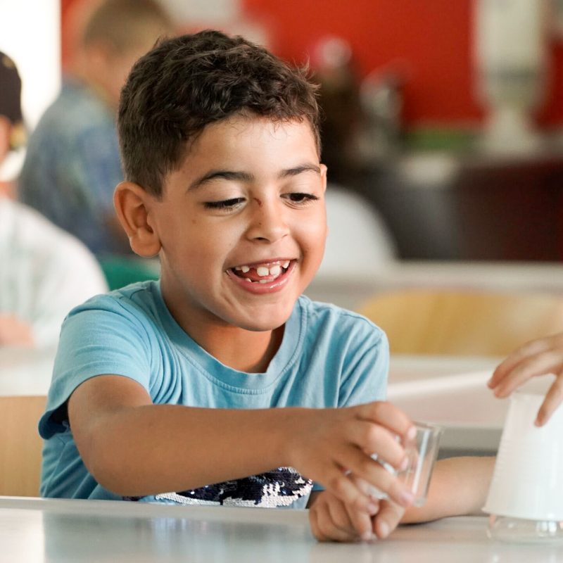 Two boys are sitting at a table in a championship.