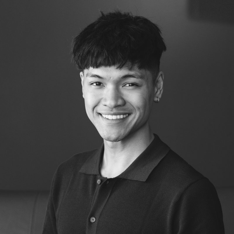 A black and white photo of Robert Haidl smiling.