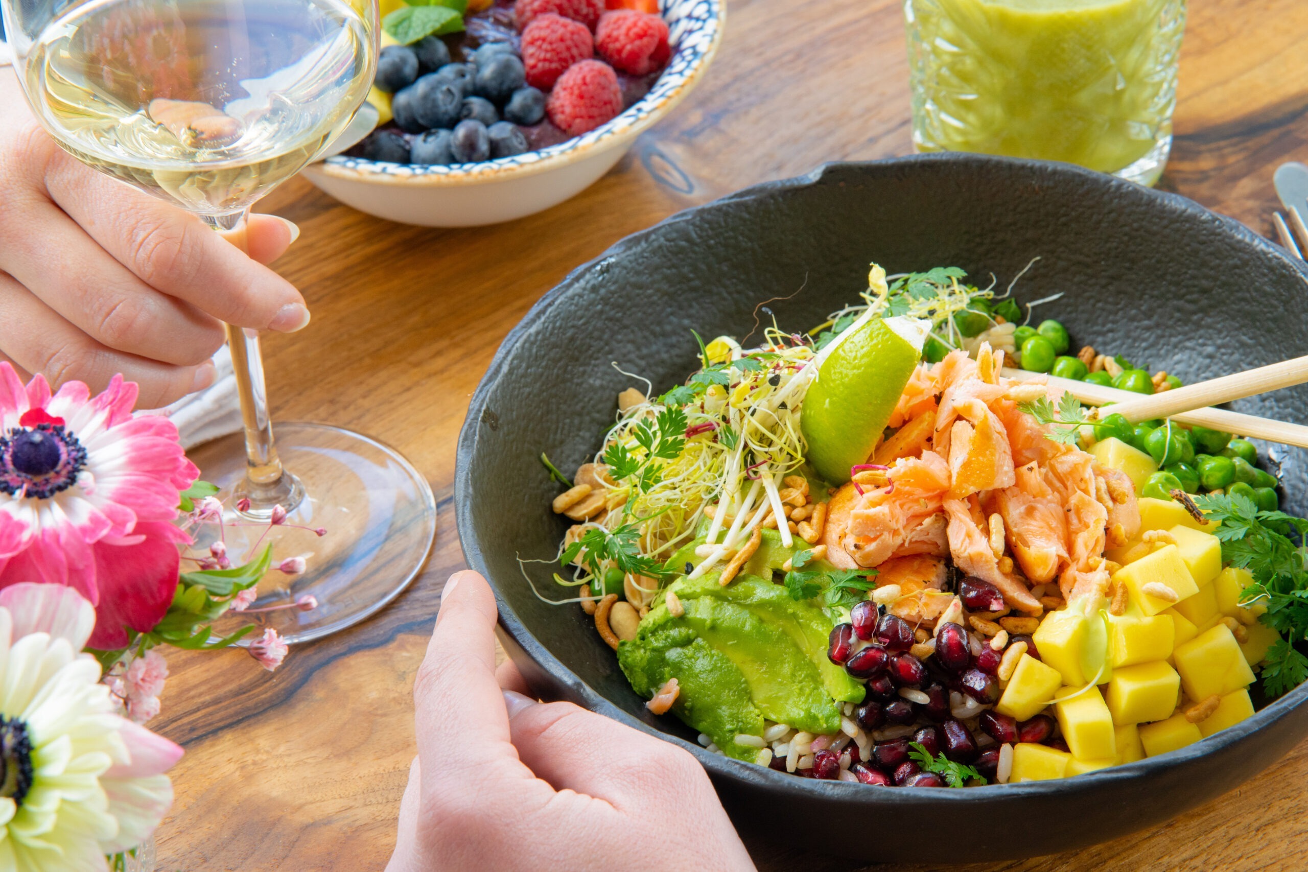 A person is enjoying a meal and wine at a Freiblick café.