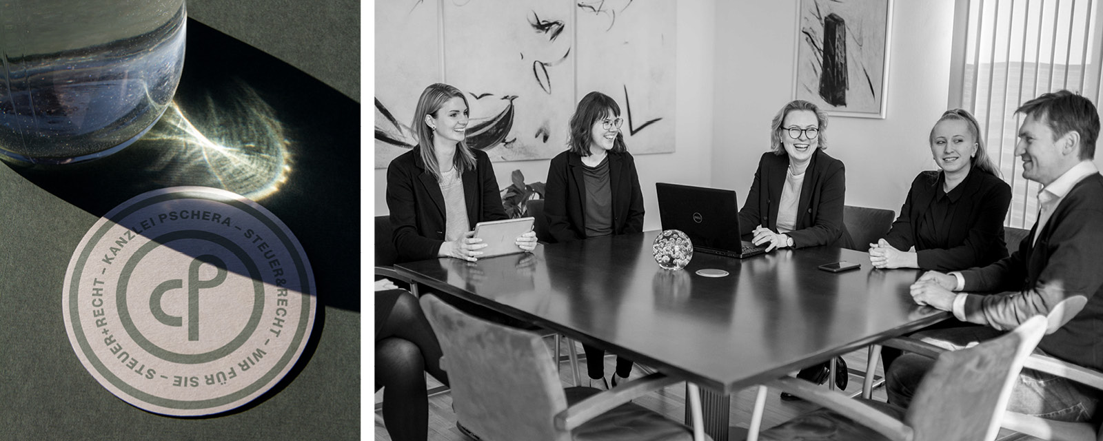 A black and white photo of a group of people sitting around a table.