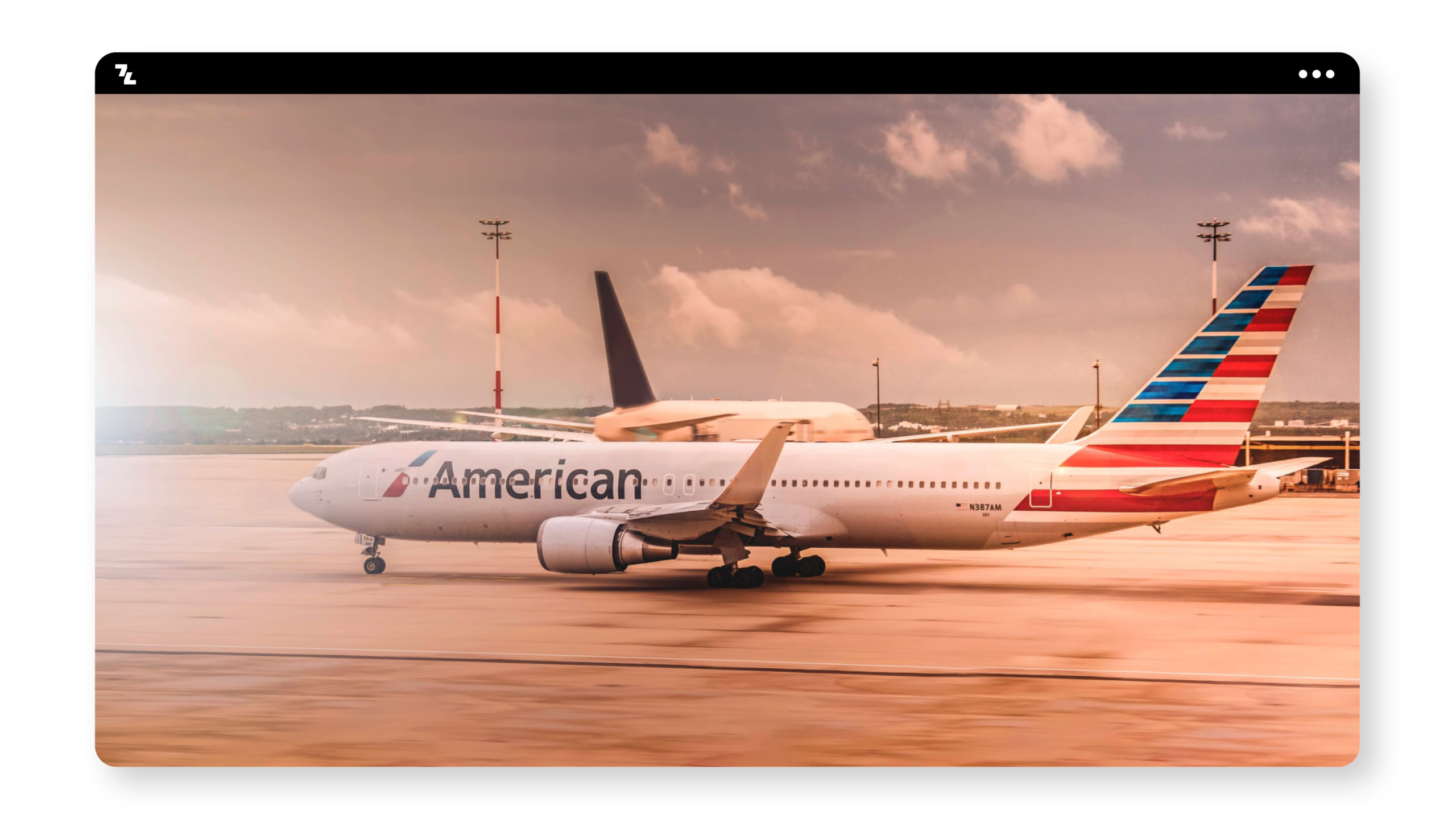 An American Airlines plane on the tarmac, protected and guided.