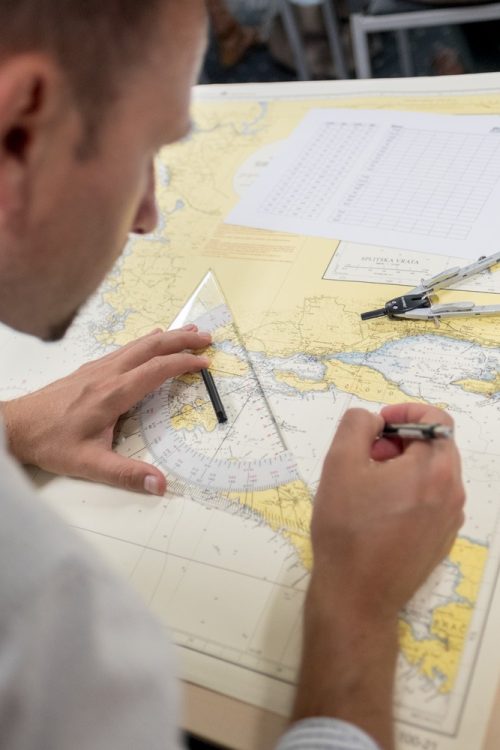 A man studying a map at a table.