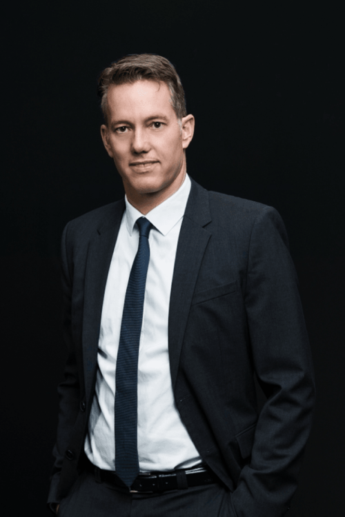 A man in a Blechinger suit posing for a photo. A man in a Blechinger suit posing for a photo.