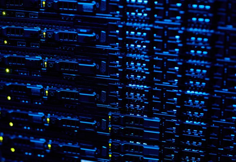 A close up of a server rack in a dark room.