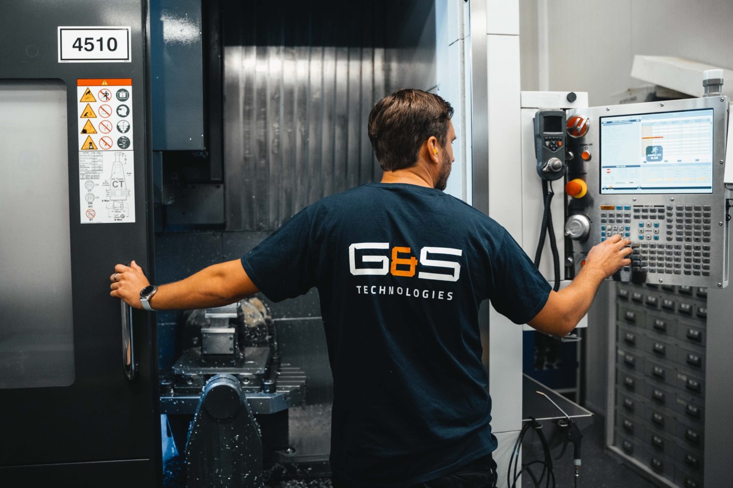 A man is working on a machine in a factory.