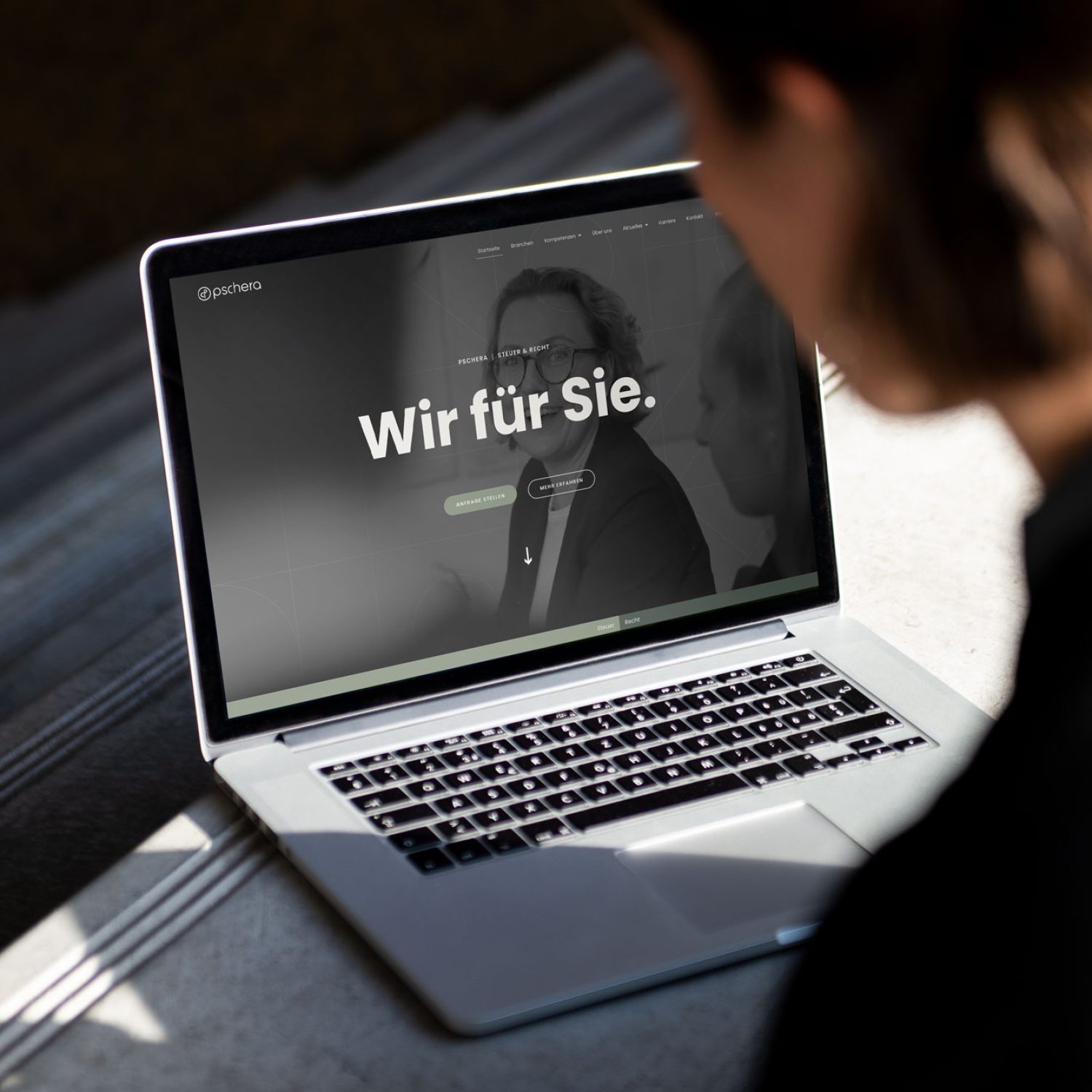 Eine Frau schaut auf einen Laptop mit der PMT-Website darauf.