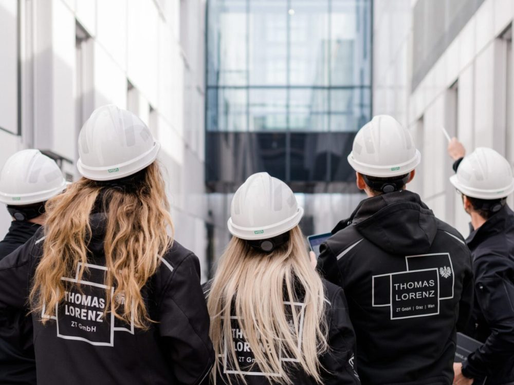 A group of construction workers wearing hard hats.