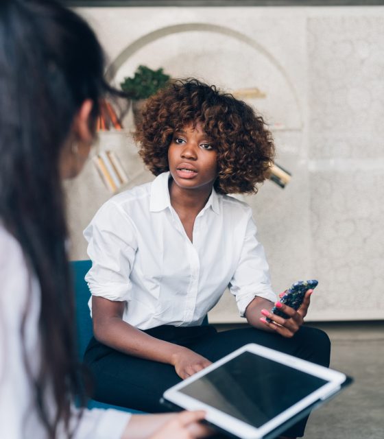 Two Firstbird employees discussing work in an office setting.