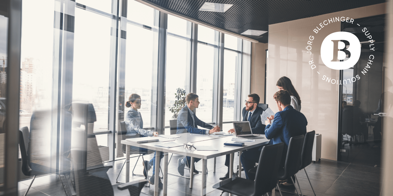 A group of Blechinger sitting around a table in a conference room. A group of Blechinger sitting around a table in a conference room.