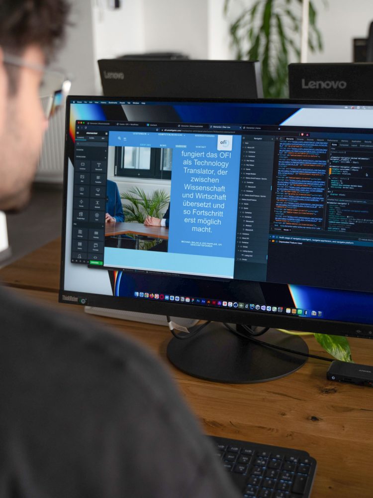 A man performing digitalization tasks at a desk with two monitors in front of him.